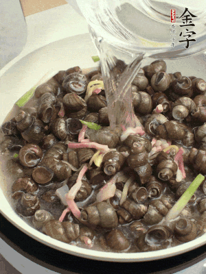 倒處理干凈的螺螄翻炒，加3勺料酒。加清水蓋過螺螄，中火蓋蓋煮5分鐘。